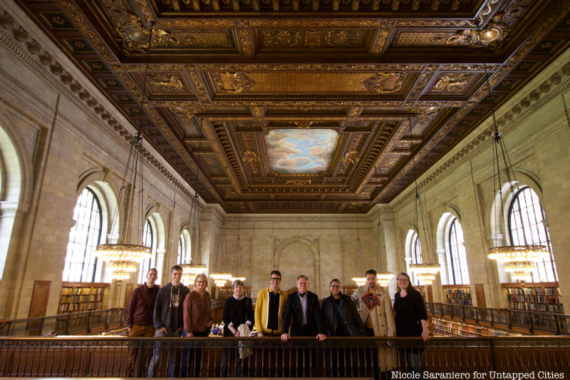 Untapped New York Insiders standing on the employee only catwalk of the NYPL Rose Reading Room
