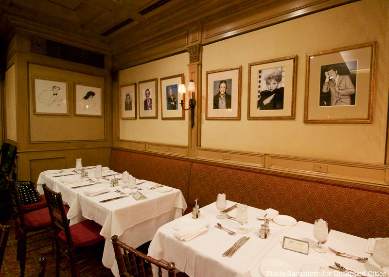 Portaits of members on the wall at the Friars Club