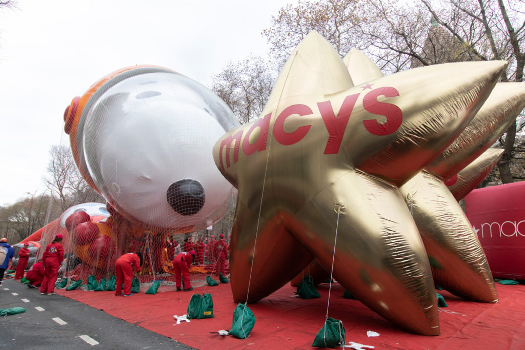 Astronaut Snoopy and gold star Macy's Thanksgiving Day parade balloons