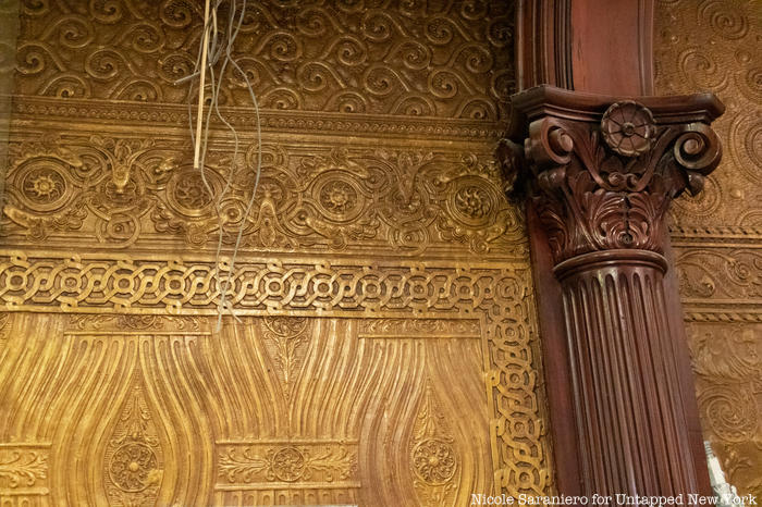 A golden patterned wall covering called Lincrusta on the wall of Gage and Tollner