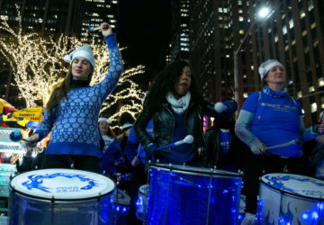 Festive drummers march through the streets of NYC