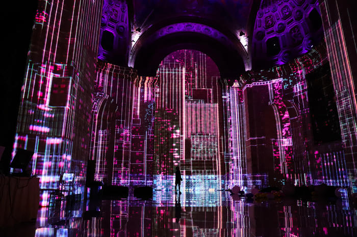 Purple images projected onto the Cunard Building in the immersive show SuperReal