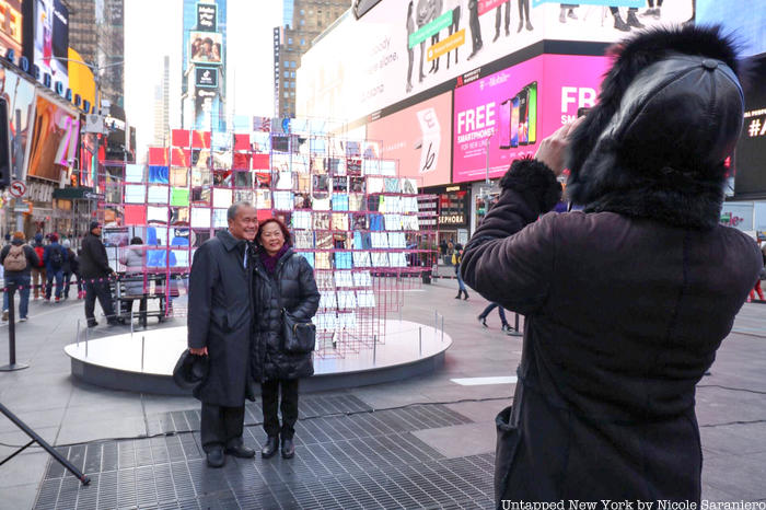 People posing in front of Heart Squared Valentines Day Heart in Times Square by MODU and Eric Forman Studio