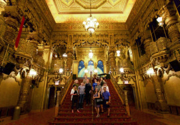 Insiders on the steps of the lobby at the United Palace Theater