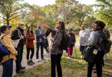 A tour group at the Seneca Village site in Central Park