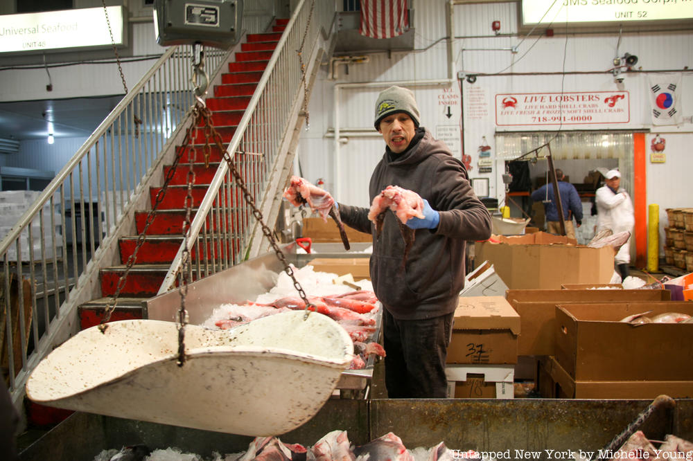 Man weighing fish at Fulton Fish Market