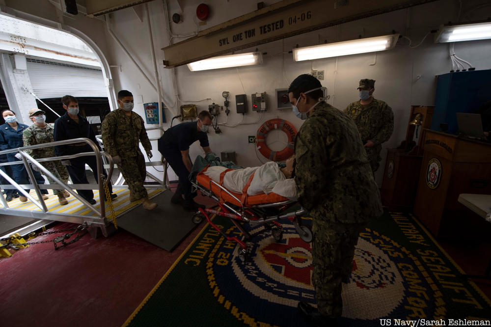 Sailors practice patient transfer from the pier onto the hospital ship USNS Comfort (T-AH 20) as they prepare to admit patients in support of the nation's COVID-19 response efforts. 