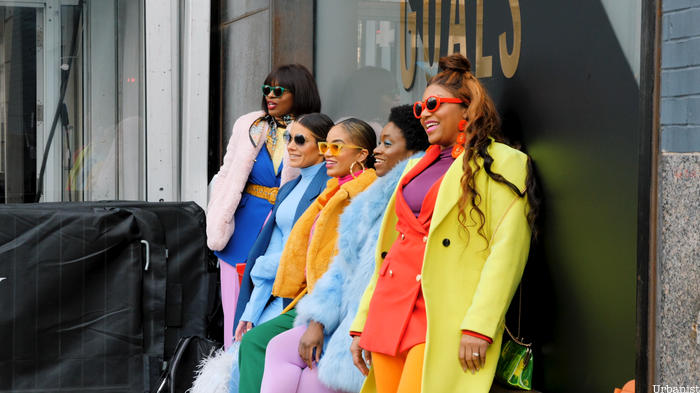 Colorfully dressed women posting in Garment District