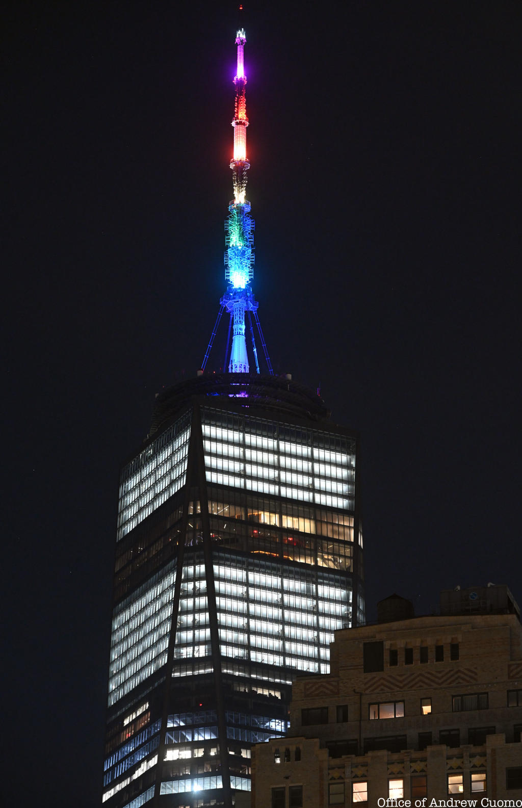 Spire of 1 WTC lit up in PRIDE colors