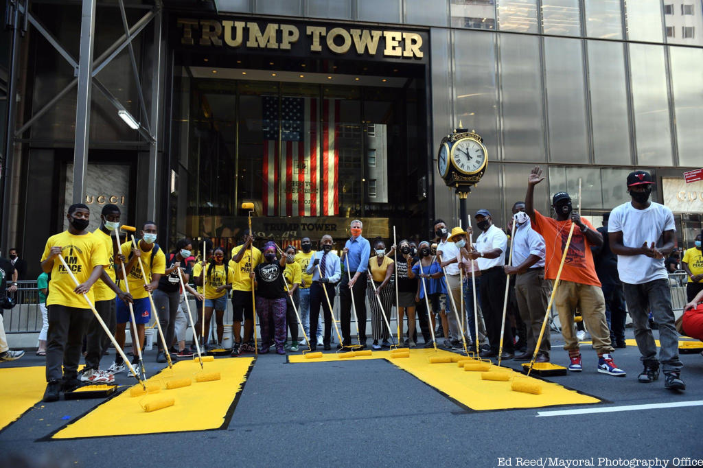 Mayor de Blasio and team painting in front of Trump Tower