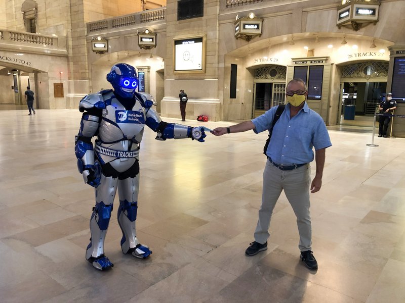 Metro Man handing out mask in Grand Central atrium