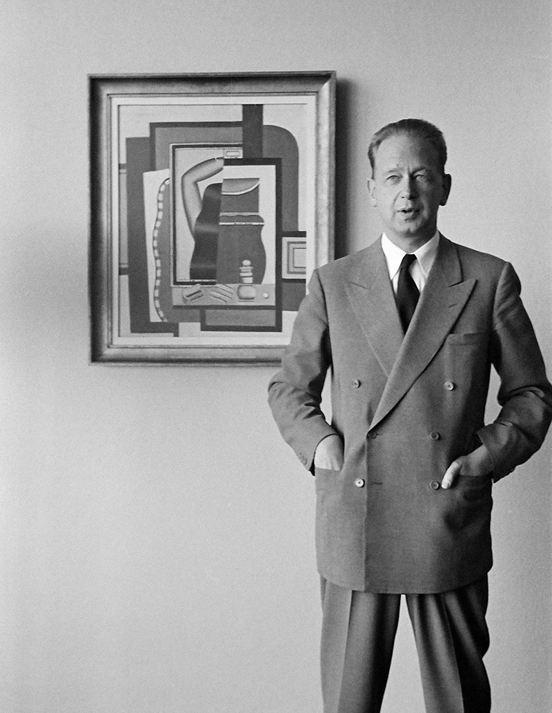 Secretary-General Dag Hammarskjöld photographed in his private apartment on the 38th floor of the Secretariat building, at United Nations Headquarters, standing in front of "Woman Combing Her Hair," a painting by Fernand Leger, lent to the United Nations by New York's Museum of Modern Art.