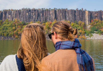 A couple admires the fall foliage at the Palisades