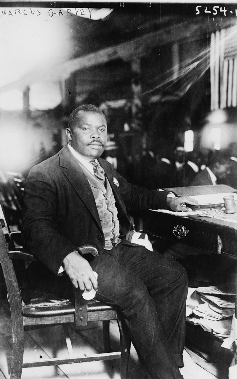 Marcus Garvey seated at desk in 1924
