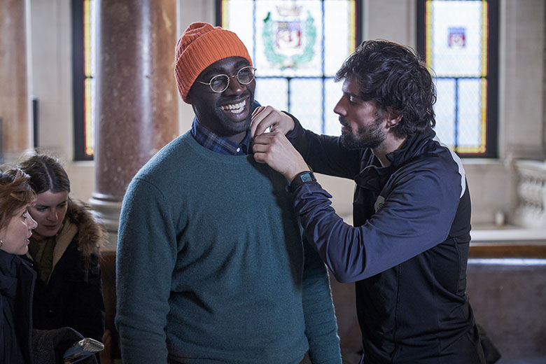 Omar Sy getting microphone set up inside filming location for Lupin in Marie 3eme