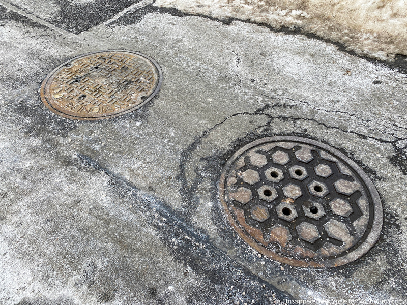 NYC manhole covers on Minetta Lane