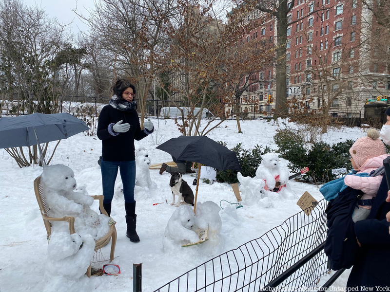 Child looking at Snowbanky sculptures in central Park
