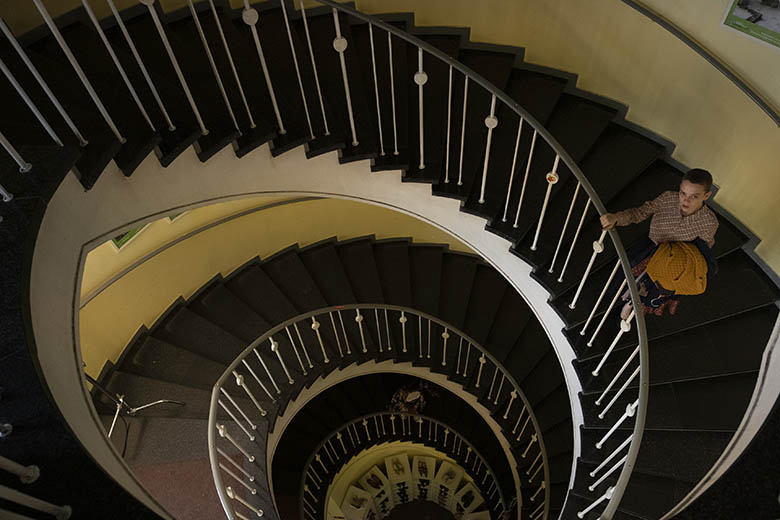 Esty Shapiro going down spiral staircase at Humana secondhand vintage store