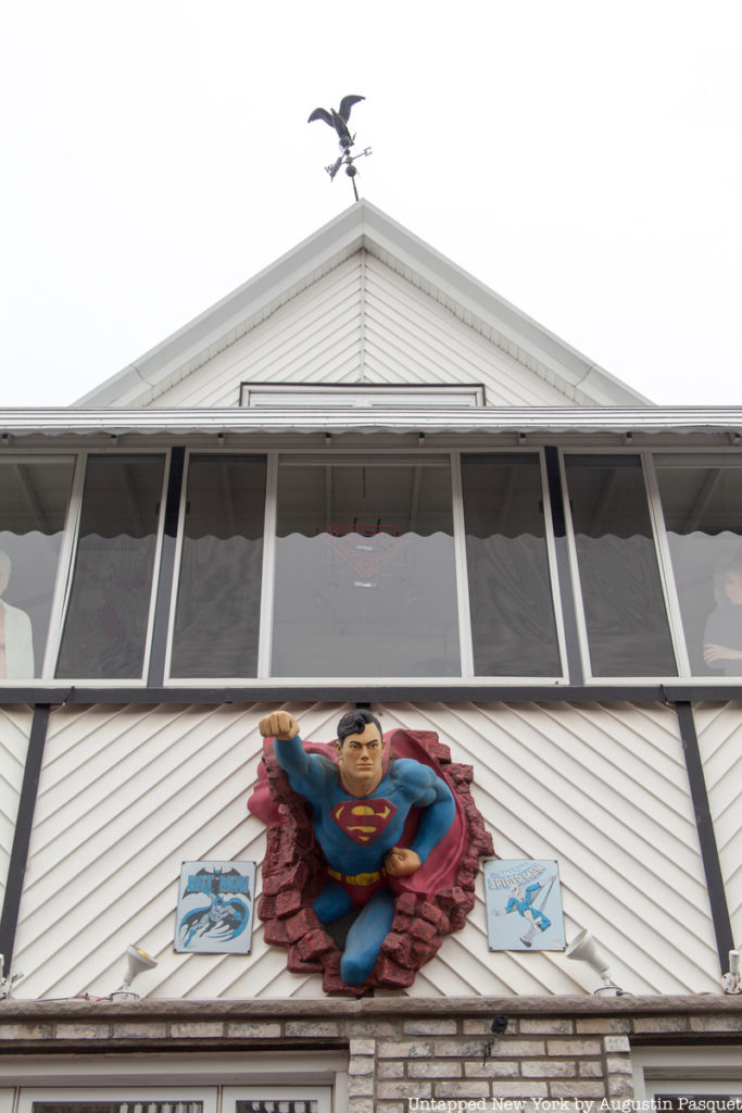 Superman flying out of house