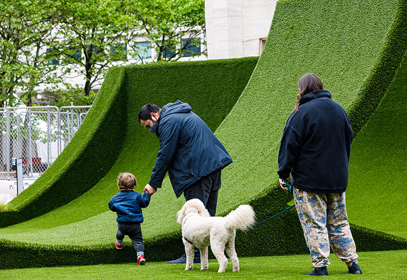 People and dog playing at The GREEN at Lincoln Center's Restart Stages