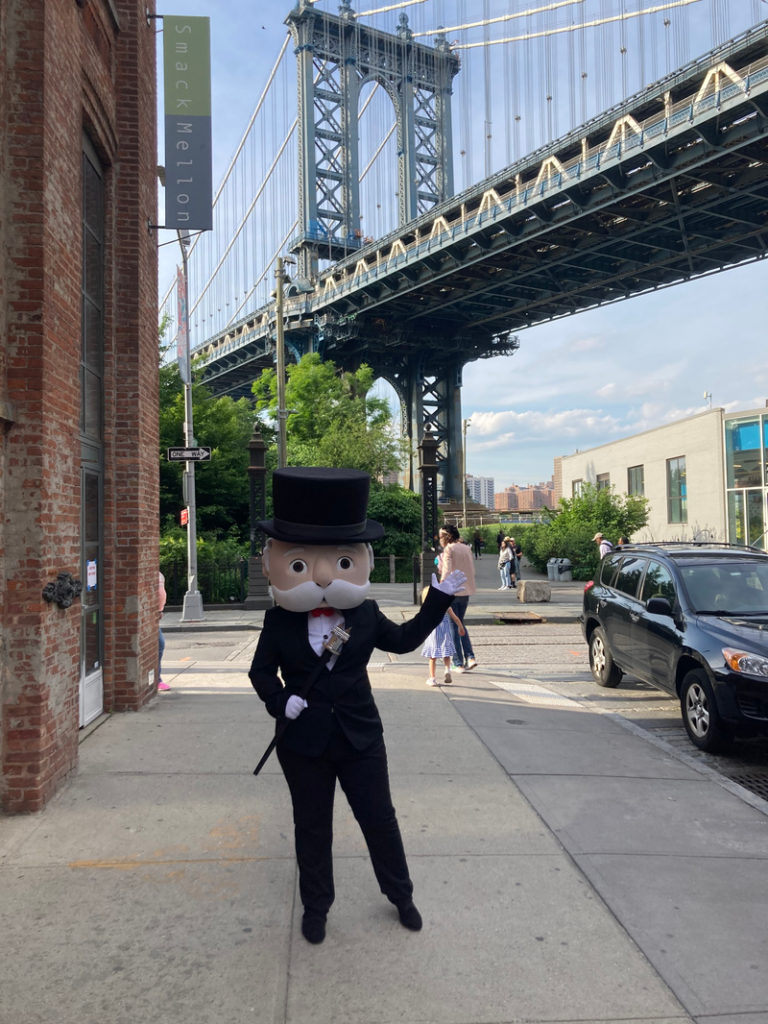 Photo of Monopoly Man near a bridge, Courtesy of MONOPOLY Brooklyn
