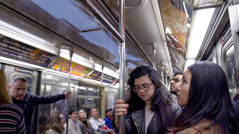 Subway riders viewing Uptown Underground 