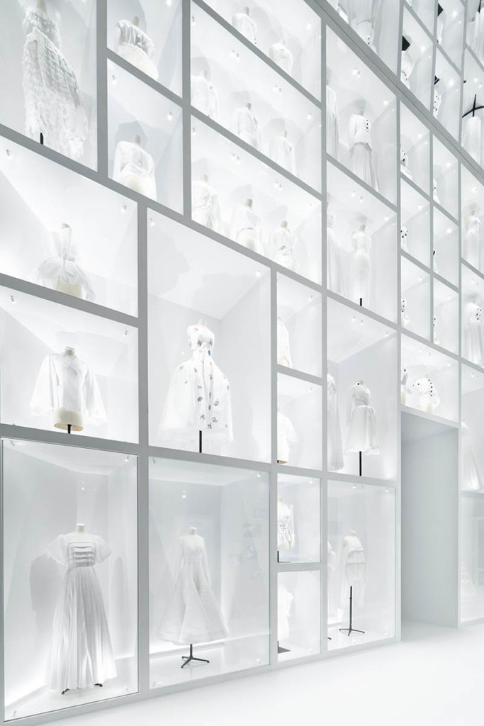 Christian Dior Designer of Dreams exhibition wall of dresses