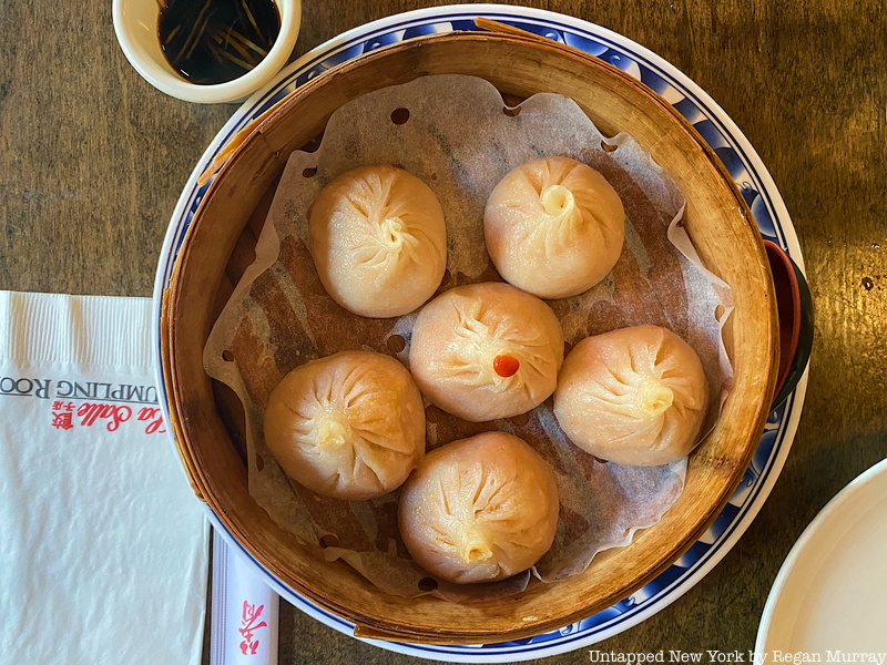 A birds-eye-view of a dumpling tray filled with six pork and kimchi soup dumplings from La Salle Dumpling Room