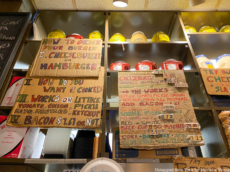 hand-written menu on cardboard at Burger Joint