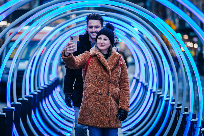 Couple enjoying the Glowing Tunnel Pedestrian in Garment District