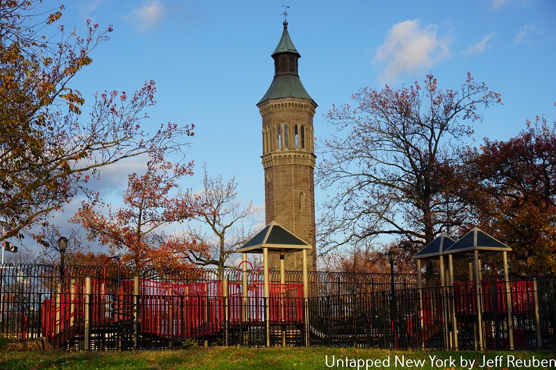 a playground with the Highbridge Water Tower behind it