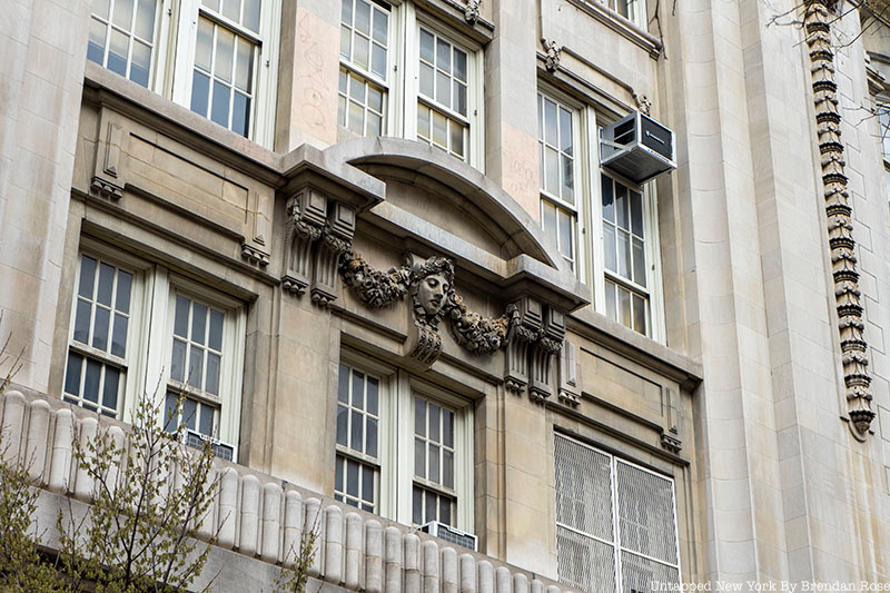 Carving of a face on the facade of the old Stuyvesant High School, March 2022.
