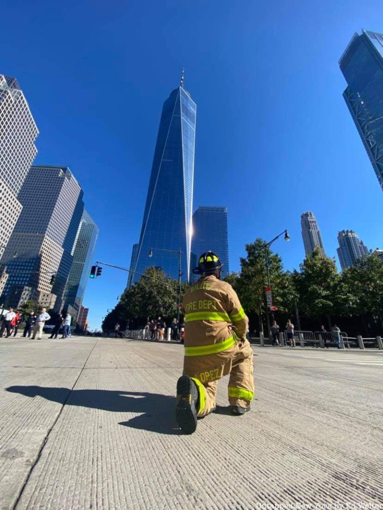 firefighter kneeling in front of 1 WTC