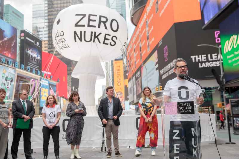 Artist Pedro Reyes and cultural leaders stand in front of mushroom cloud sculpture "ZERO NUKES" in Times Square.