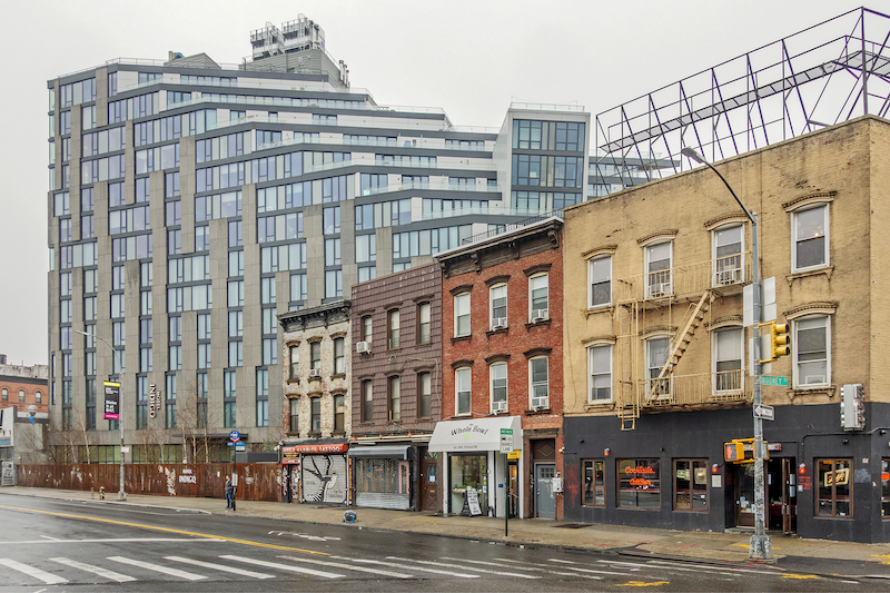 glassy hotel in contrast with older buildings in Williamsburg