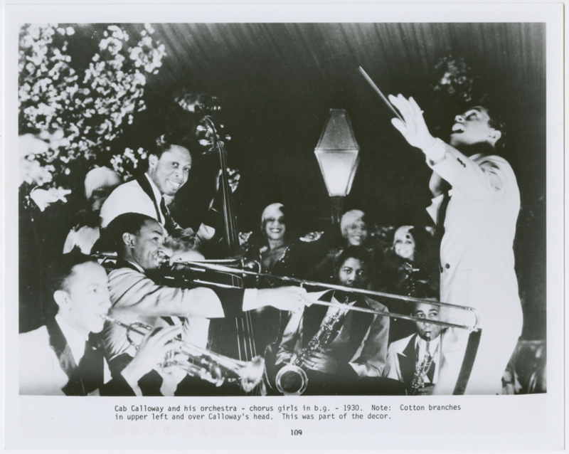 The Cotton Club's Cab Calloway performing on stage with his band, a former jazz club in NYC