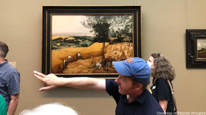 Tour guide Patrick Bringley points to paintings in the Met
