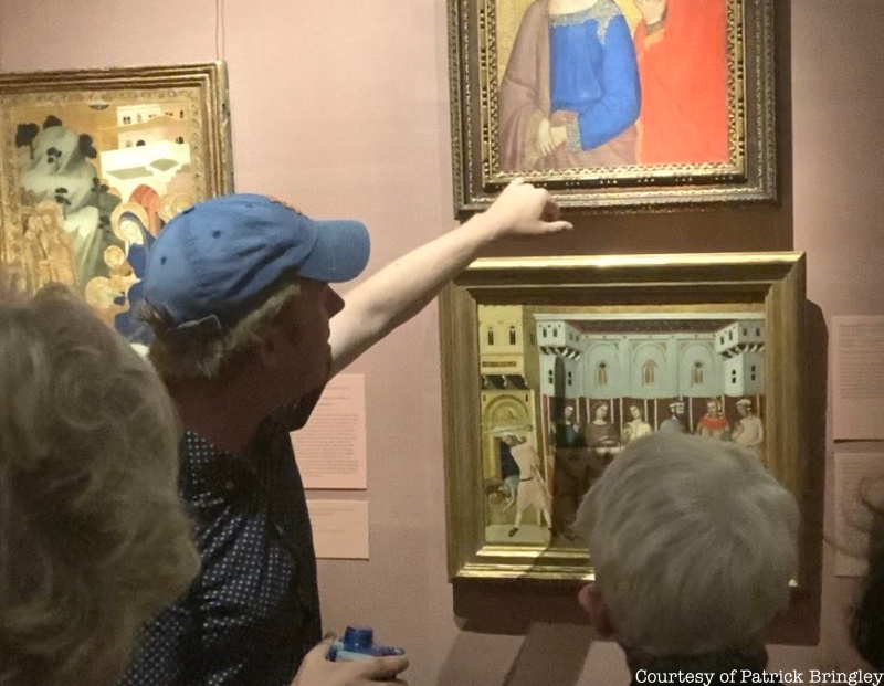 Tour guide Patrick Bringley points to a painting at the Met Museum