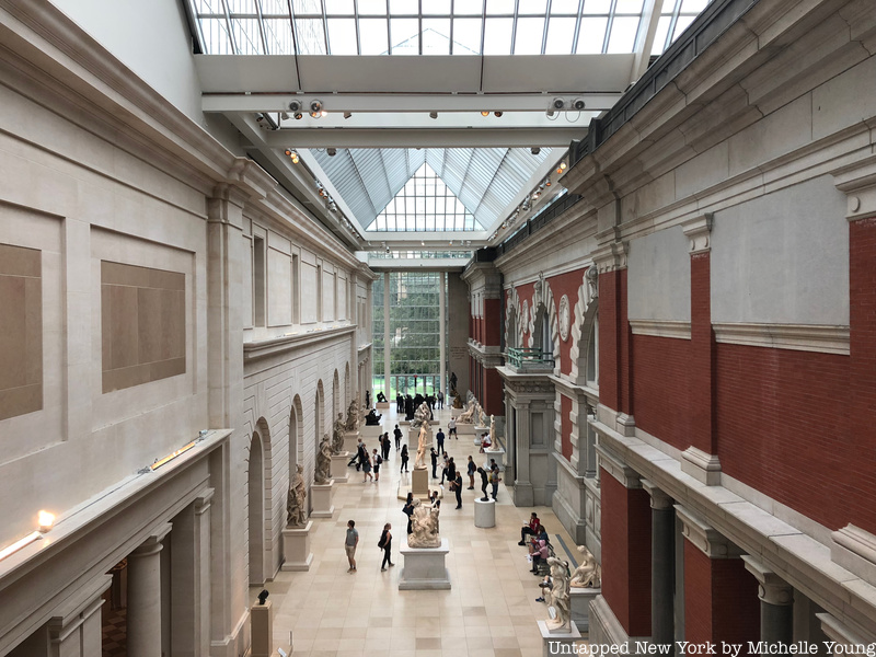 A sunlit overhead view of a corridor in the Metropolitan Museum of Art