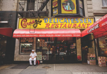 A man sits outside NYC's Jewish deli Carnegie's Deli.
