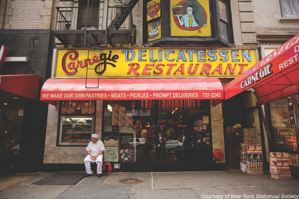 A man sits outside NYC's Jewish deli Carnegie's Deli.