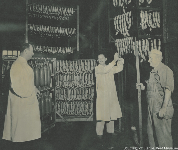 Three men inspect sausages at Chicago's Vienna Beef Factory