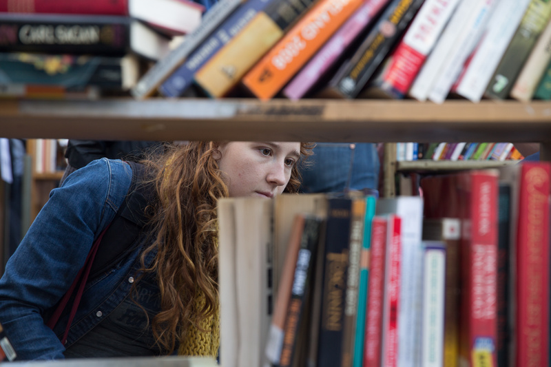 A woman browses the bookshelves at Brooklyn Public Library
