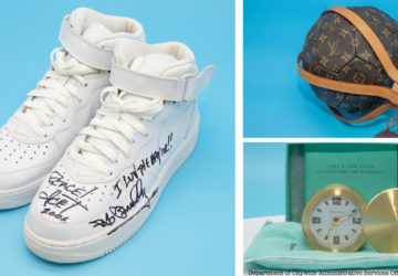 A pair of sneakers, a Louis Vuitton soccer ball and a gold desk clock