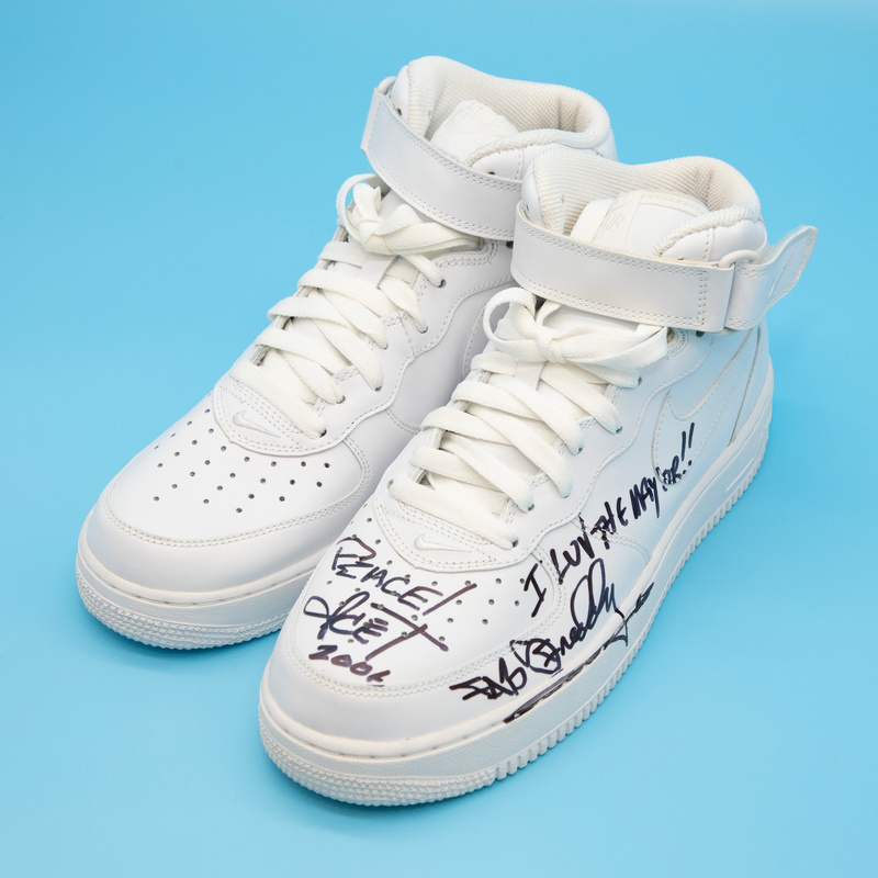 A pair of white, autographed Nike Air Force Once Sneakers