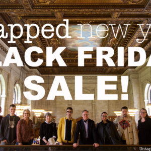 Insiders inside the NYPL. White letters on top of image say Untapped New York Black Friday Sale
