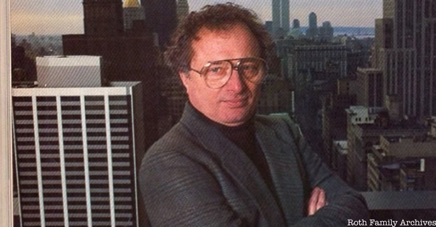 Richard Roth Jr. stands in front of a background of the NYC skyline
