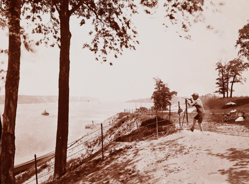 A boy with a telescope in a sepia toned image of Riverside Drive