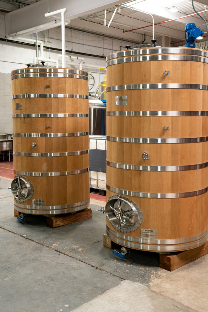 Large wood and metal barrels at Arcane Distillery