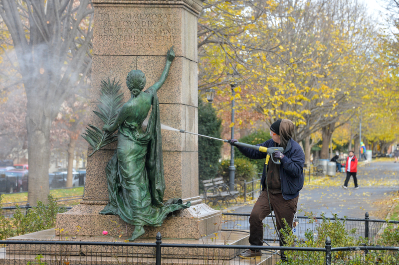 A bronze statue, "Fame" at the Heintz Monument, is powerwashed